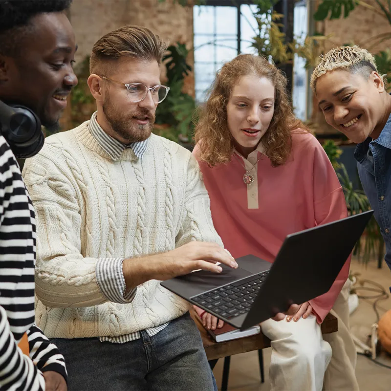Gruppe von Menschen schaut auf Laptop. Gruppe von Menschen schaut auf Laptop.